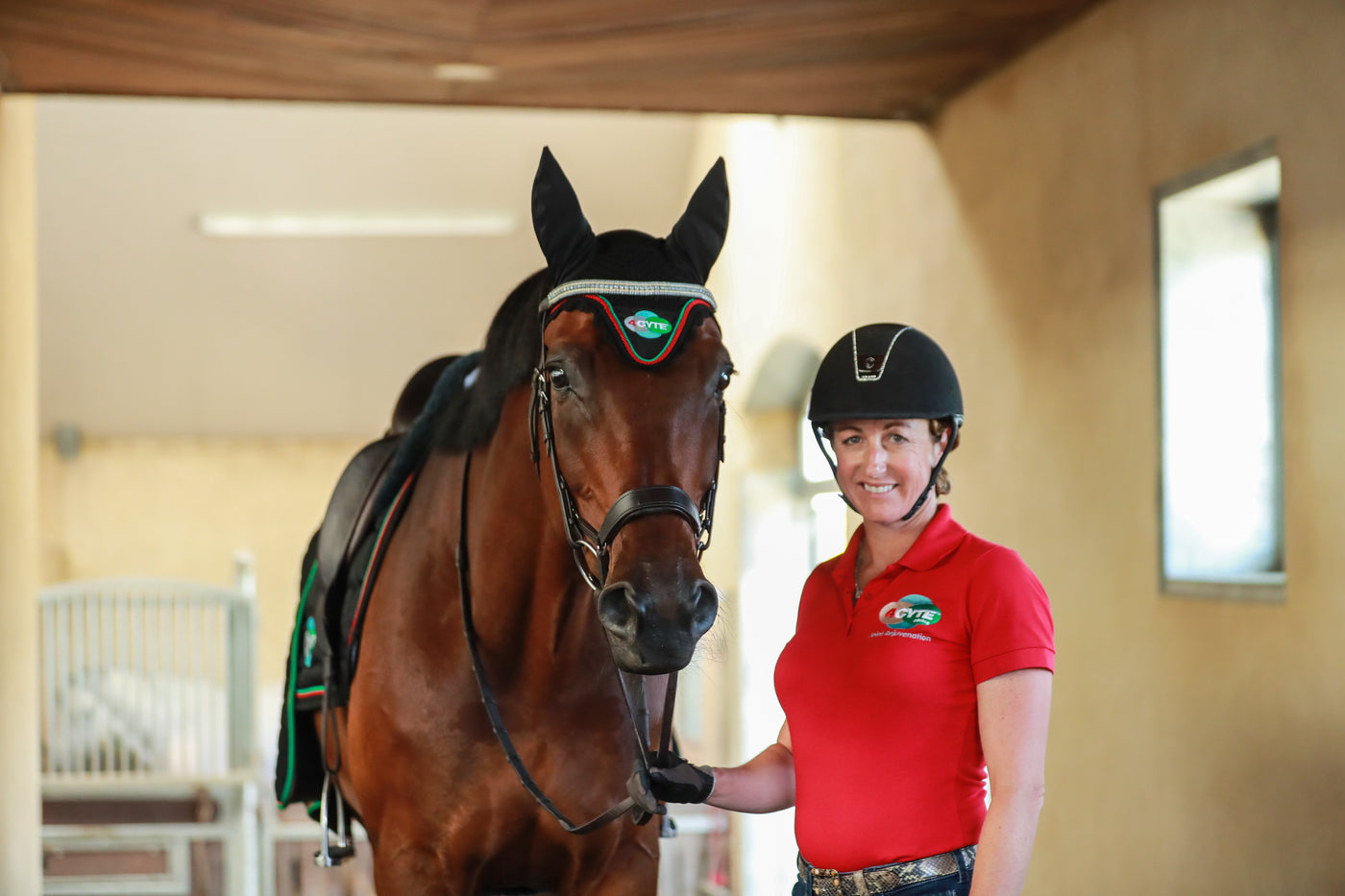 Woman stood next to horse and smiling